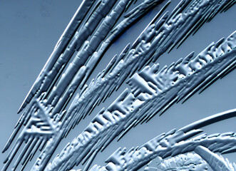 Fototapeta premium Drawings of ice on blue glass.