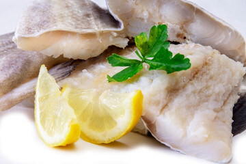 fresh cod with parsley and lemon isolated on white