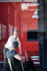 Fototapeta na wymiar Serious strategizing. Shot of two handsome businessmen having a discussion in the office.