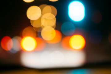 Bokeh blur from car taillights at night on the road