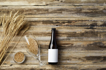 A bottle of beer and grain. Top view. Free space for text.