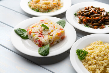 Variety of garnishes like cooked rice, bulgur, stewed cabbage and green beans