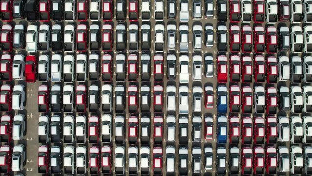 Top View,Aerial new car storage parking lot showing imported new vehicles or ready to export new automobiles storage facility car industry for export all over the world market for car sales