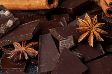chocolate, cocoa, nuts and spices on wooden background