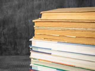 Stack of books on a wooden background. Education and training.