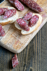 sliced pieces of sausage from meat are lying on a cutting board
