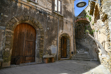 A narrow street among the old stone houses of Castellabate, town in Salerno province, Italy.	
