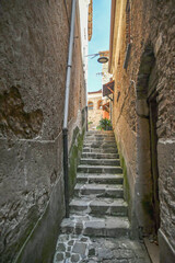 A narrow street among the old stone houses of Castellabate, town in Salerno province, Italy.	
