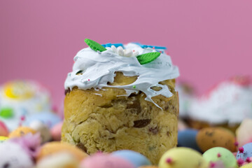 Easter card. Kulich kraffin with sugar fudge on a pink background. Marshmallow fudge.