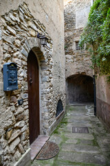 A narrow street among the old stone houses of Castellabate, town in Salerno province, Italy.	