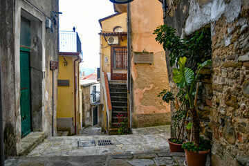 Fototapeta na wymiar A narrow street among the old stone houses of Castellabate, town in Salerno province, Italy. 