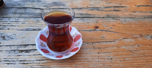 Turkish tea with traditional coaster on the wooden table. outside cafe drink service photo concept idea.