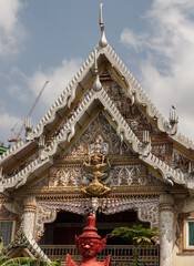 Bangkok, Thailand. Mar - 12, 2022 : Stucco figure the red giant standing guardian at the entrance of the ordination hall in Wat khlong phum temple. No focus, specifically.