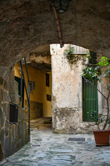 A narrow street among the old stone houses of Castellabate, town in Salerno province, Italy.	