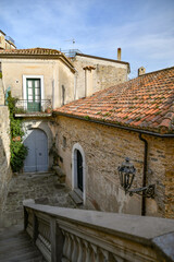 A narrow street among the old stone houses of Castellabate, town in Salerno province, Italy.	