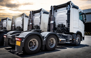 Semi Trailer Trucks The Parking Lot with Sunset Sky. Distribution Warehouse. Shipping Trucks. Diesel Truck Lorry Tractor. Industry Freight Truck Logistics Cargo Transport. © Siwakorn1933
