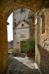 A narrow street among the old stone houses of Castellabate, town in Salerno province, Italy.	