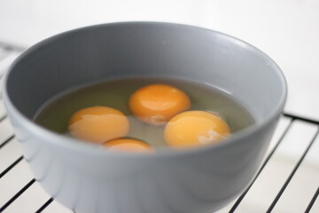 broken raw eggs in the gray case.