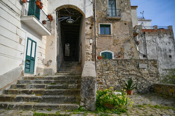 A narrow street among the old stone houses of Castellabate, town in Salerno province, Italy.	