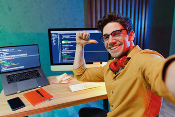 Close up young software engineer IT programmer man in shirt work at home write program code on...