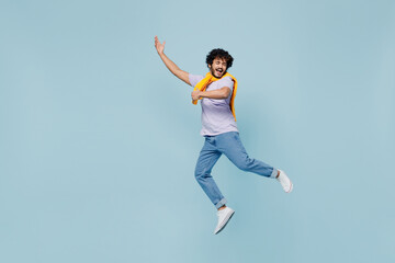 Fototapeta na wymiar Full size body length amazing happy young bearded Indian man 20s years old wears white t-shirt singing song dreaming like playing guitar isolated on plain pastel light blue background studio portrait.
