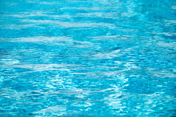 Abstract ripple wave and clear turquoise water surface in swimming pool, blue water wave for background and abstract design.