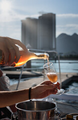 champagne pours into a glass on a yacht