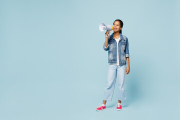 Full body little kid teen girl of African American ethnicity 12-13 years old in denim jacket hold scream in megaphone announces discounts sale Hurry up isolated on pastel plain light blue background