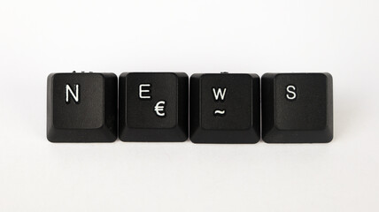 News text created with keyboard keys isolated on white background, white news letters on black keyboard, top view