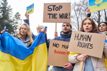 Group of young caucasian people manifesting against Ukrainian war