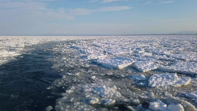 流氷の中を進む観光船から見る知床連山