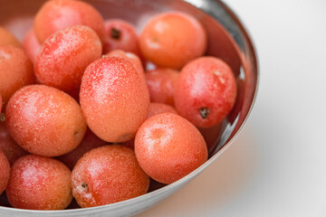 red fruits in a bowl