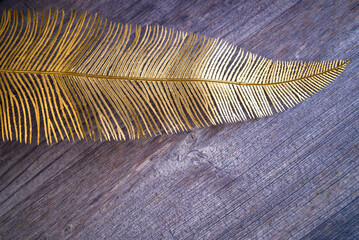 Palm leaf painted in gold color. Decoration on the table. copy space