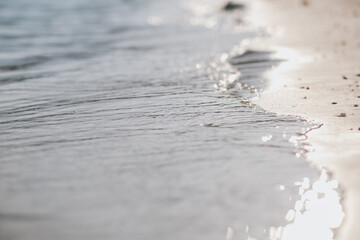 Closeup image of the sea and white sand beach