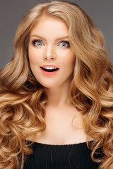 Surprised young woman smiling in studio smiling