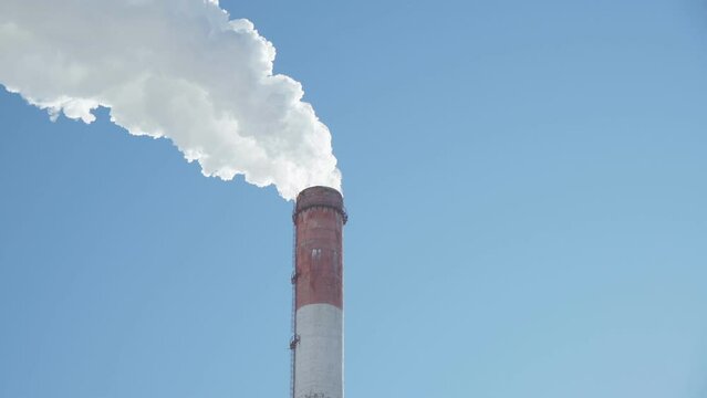 Smoke stack with smoke emission. Plant pipes pollute atmosphere. Industrial factory pollution.