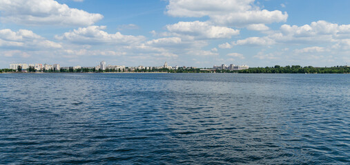 Voronezh. Blue waves of river and line of new houses on other side. White clouds in blue sky. Beautiful nature landscape with Voronezh river. There is place for your text.