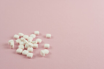 Mint pads for fresh breath close-up on a pink background