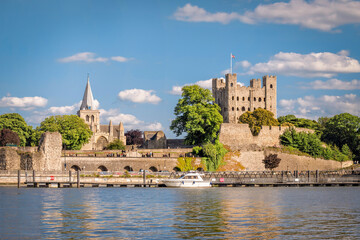 RView of historical Rochester across river Medway in sunny afternoon, England