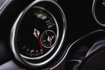 Speedometer at dashboard of luxury sport car, close-up view, vehicle wallpaper and background photo