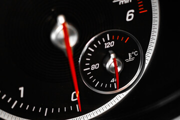 Cooling temperature gauge of a car, glowing indicator close-up view - obrazy, fototapety, plakaty