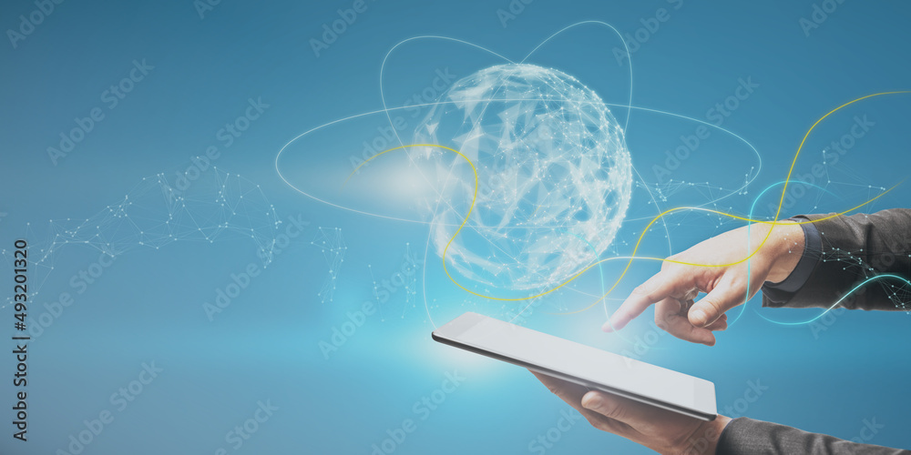 Poster Close up of businessman hand pointing at tablet with abstract polygonal sphere on blue background with mock up place. Metaverse and future concept.