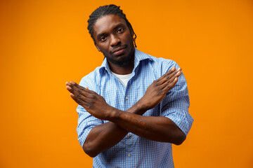 Portrait of serious African American male showing hand stop sign