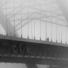 Man on Podilsko-Voskresenskyi Bridge in fog