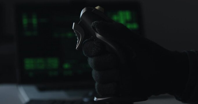 Hand of a military pilot controls a remote spy surveillance drone for warfare
