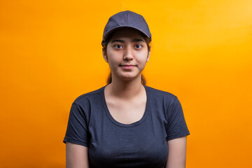 Confident young delivery woman standing isolated on Yellow Background