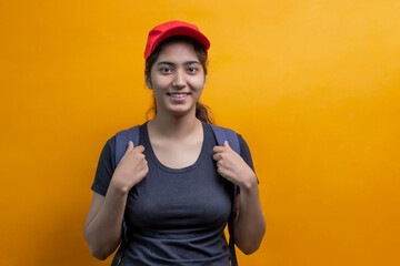 PORTRAIT OF A Delivery Woman STANDING WITH BAG LOOKING HAPPILY AT CAMERA