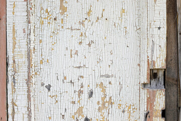 Old white wall texture with peeling background. Closeup. Old door.