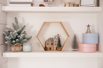 Wall shelves with beautiful Christmas decor indoors. Interior design