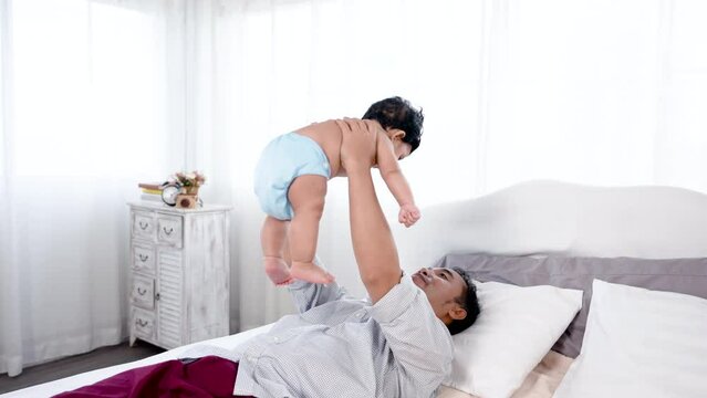 4K 50fps, Single father happily playing with his cute son, father teasing his son mischievously and kisses son warmly. Family and Healthy..